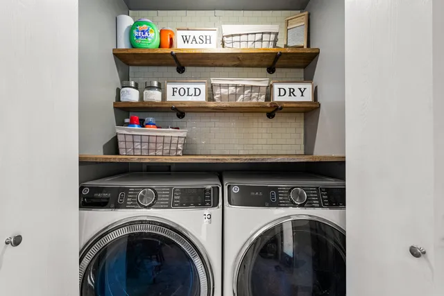a view of washer and dryer with rug
