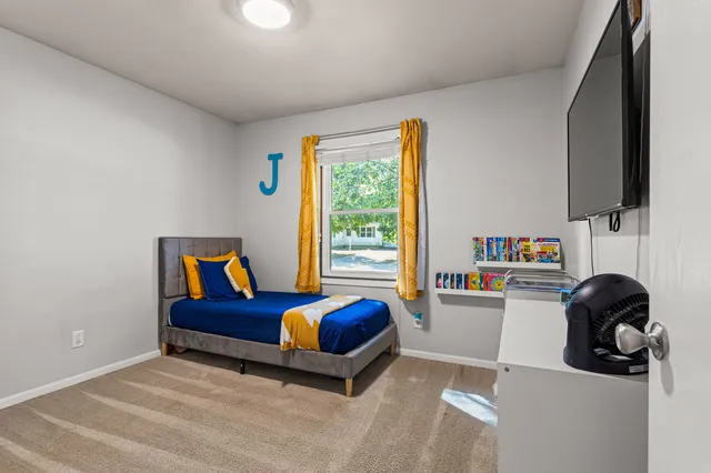 a bedroom with a bed and a window