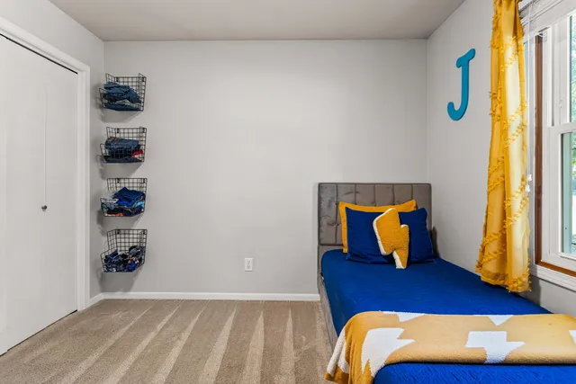 a bedroom with a bed and window