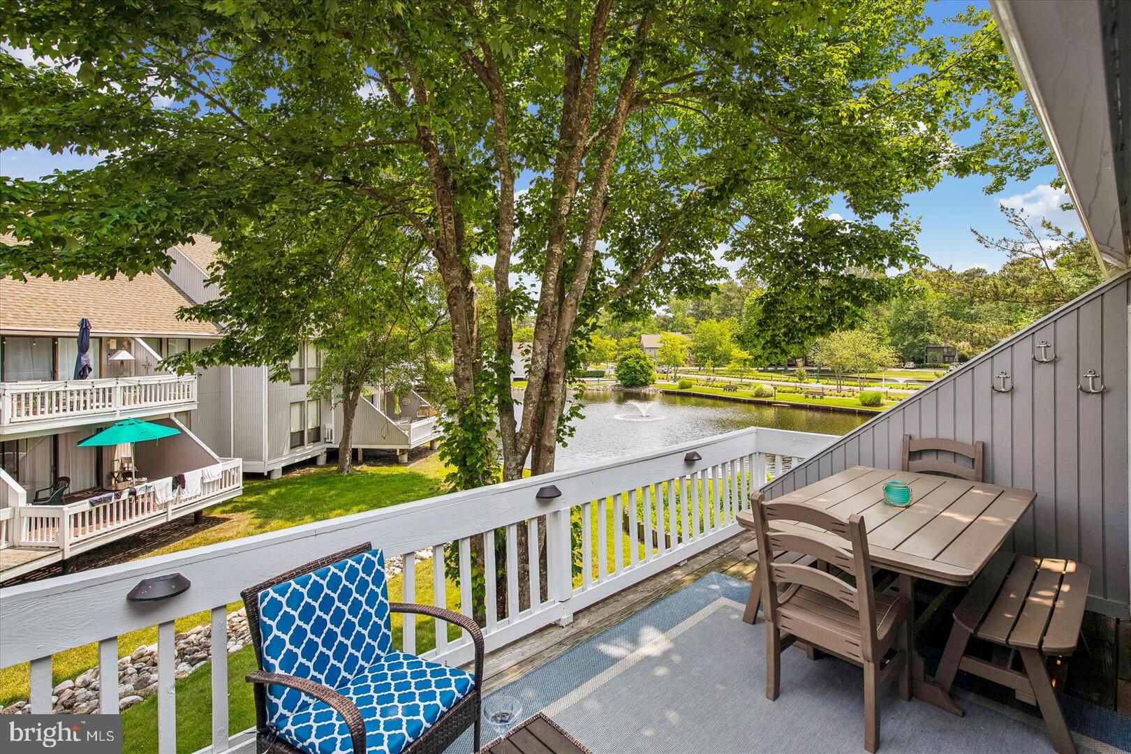 39689 Round Robin Way, Unit 3103 Bethany Beach, DE 19930 - Photo 11 of 34 a view of balcony with wooden floor outdoor seating and yard