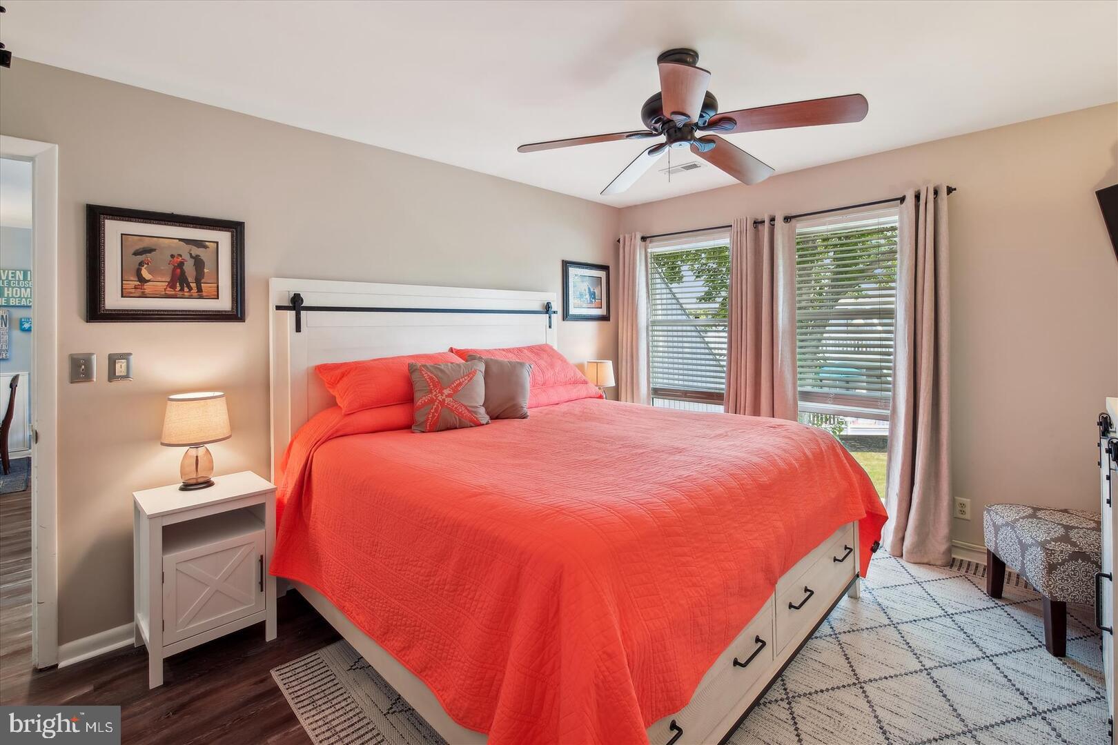 39689 Round Robin Way, Unit 3103 Bethany Beach, DE 19930 - Photo 14 of 34 a bedroom with a bed and a chandelier