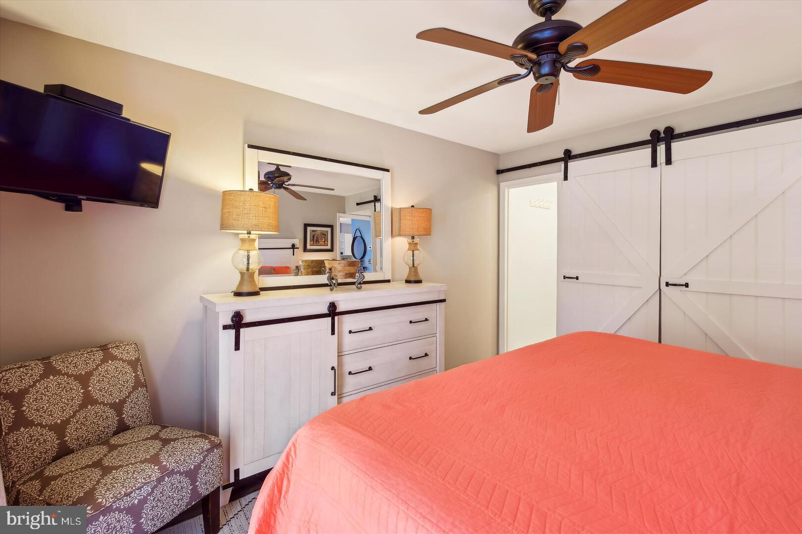 39689 Round Robin Way, Unit 3103 Bethany Beach, DE 19930 - Photo 15 of 34 a bedroom with a bed and furniture