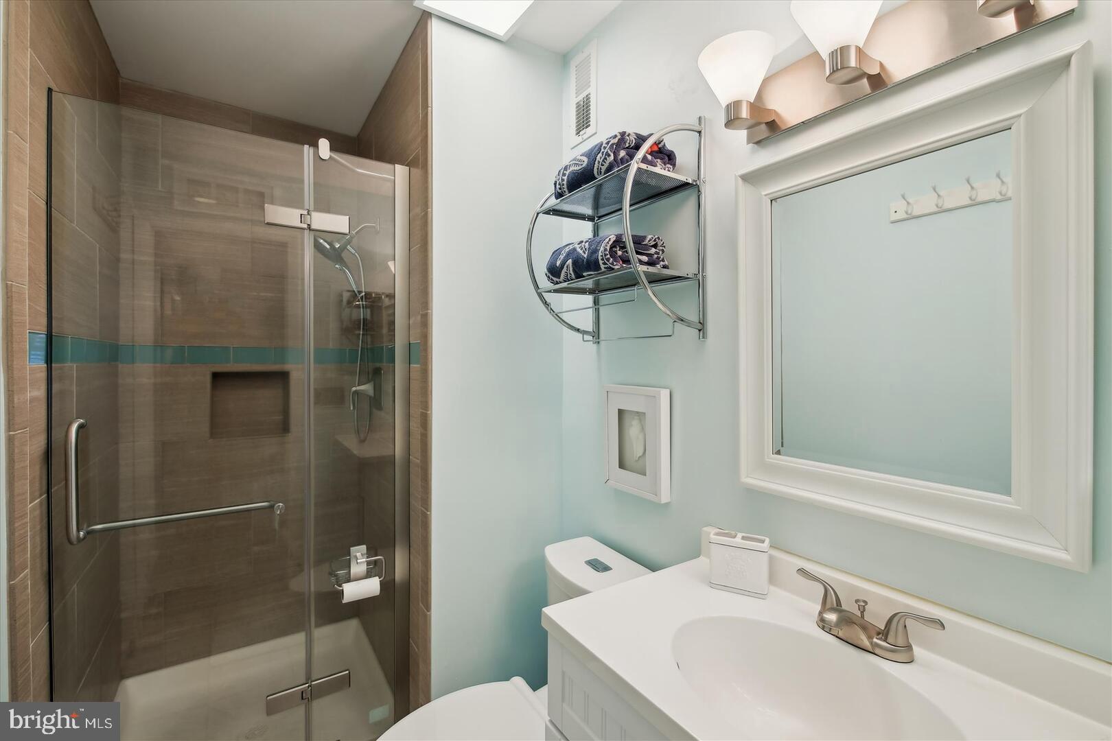 39689 Round Robin Way, Unit 3103 Bethany Beach, DE 19930 - Photo 16 of 34 a bathroom with a sink toilet and shower