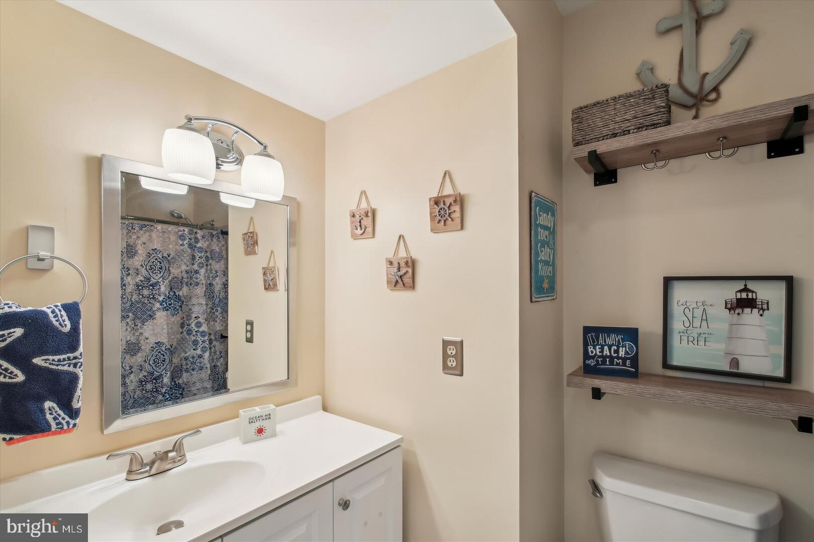 39689 Round Robin Way, Unit 3103 Bethany Beach, DE 19930 - Photo 19 of 34 a bathroom with a sink mirror and a shower