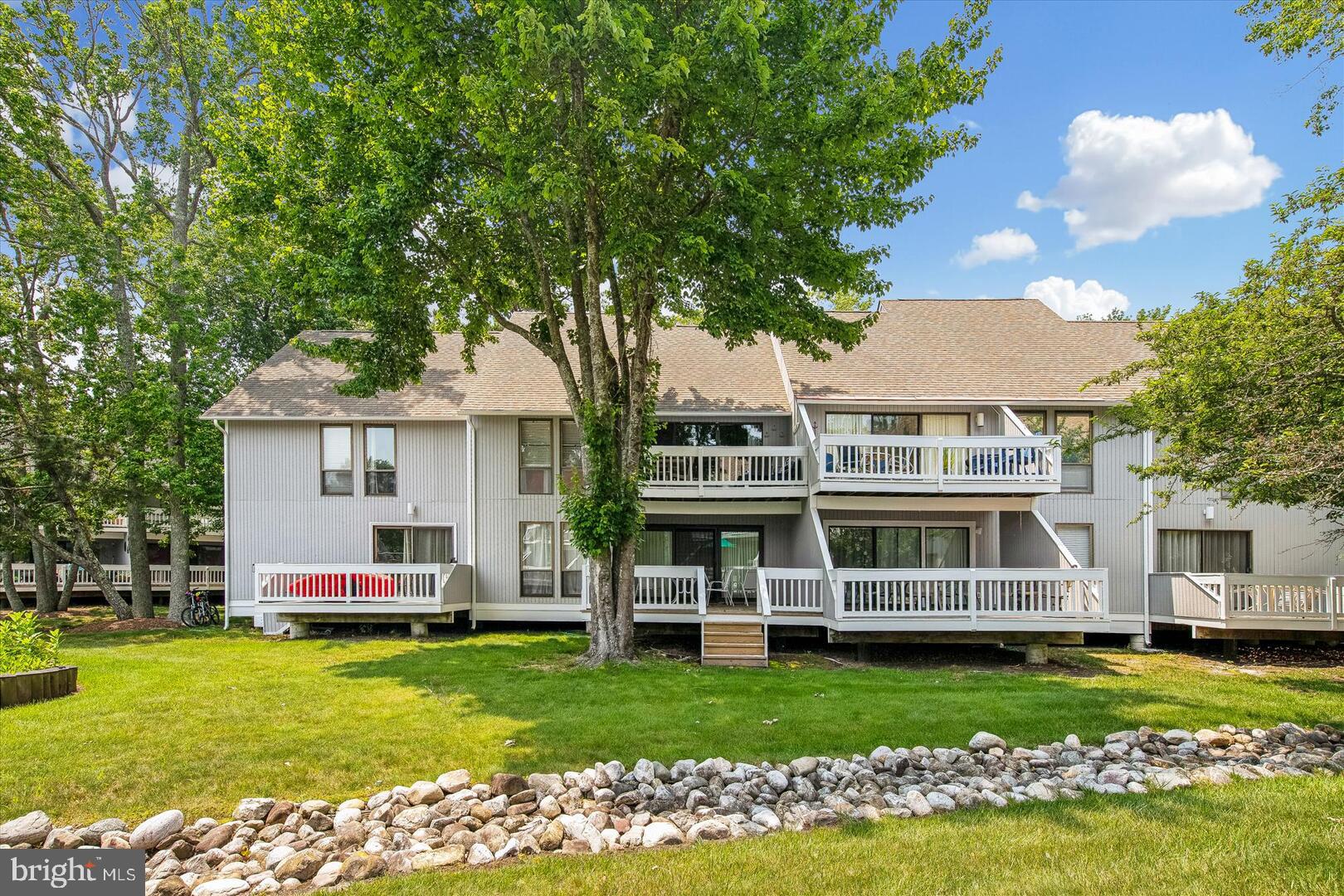 39689 Round Robin Way, Unit 3103 Bethany Beach, DE 19930 - Photo 23 of 34 a front view of a house with a garden