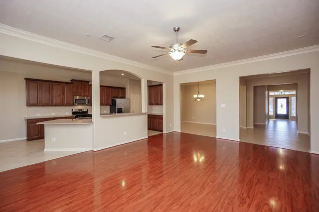 a view of a kitchen with furniture and wooden floor