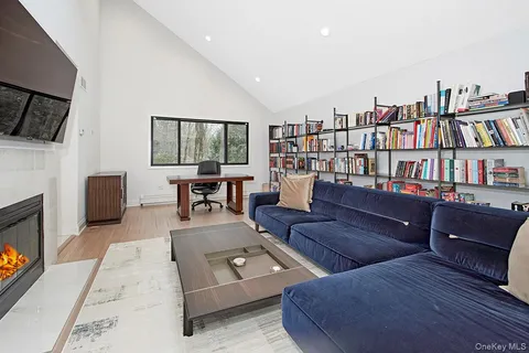 a living room with furniture fireplace and flat screen tv