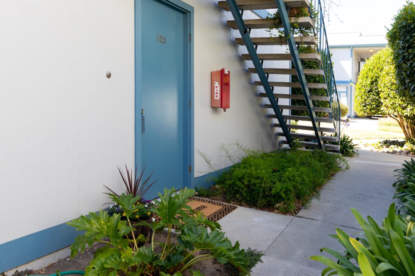 1925 46th Avenue, Unit 105 Capitola, CA 95010 - Photo 4 of 27 a front view of a house with a yard