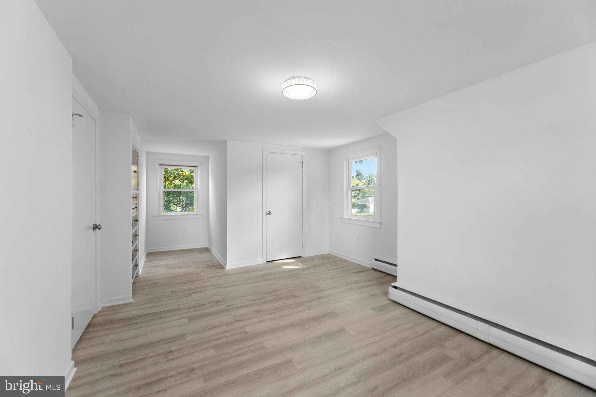 245 Paxson Avenue Hamilton, NJ 08690 - Photo 13 of 26 an empty room with window and wooden floor