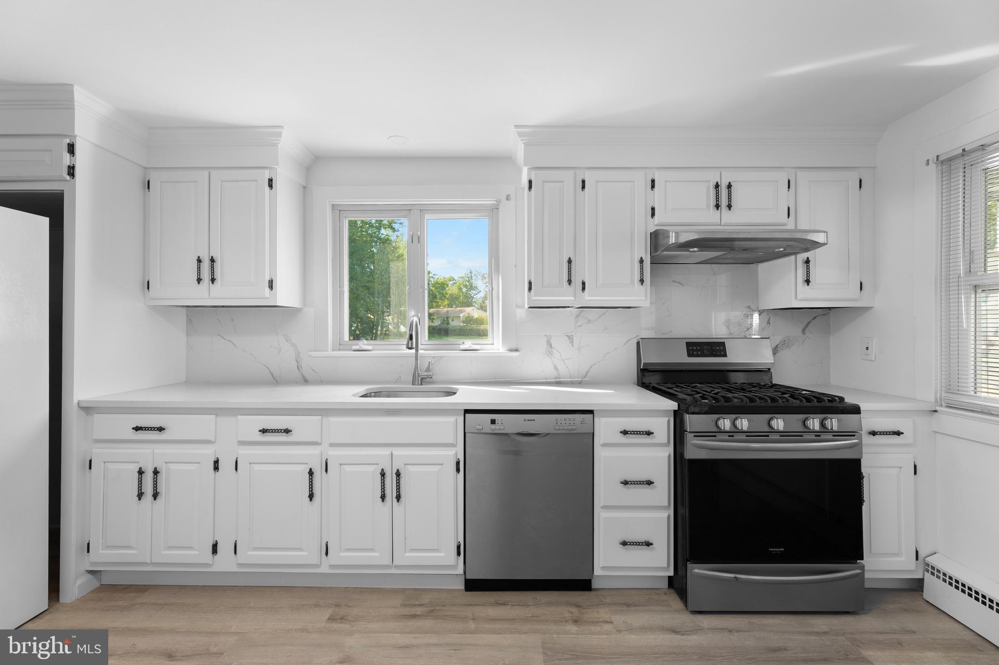245 Paxson Avenue Hamilton, NJ 08690 - Photo 3 of 26 a kitchen with stainless steel appliances granite countertop a stove and a white cabinets