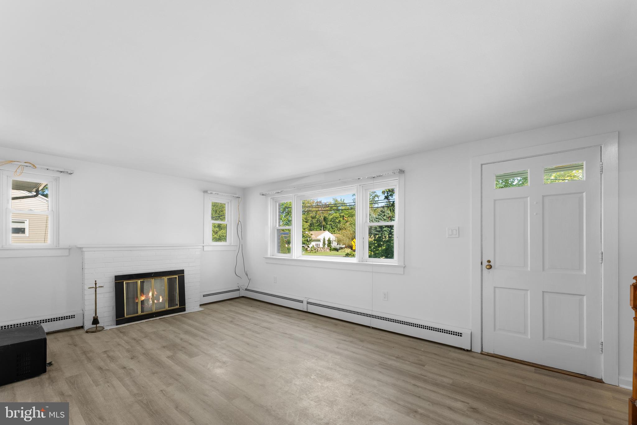 245 Paxson Avenue Hamilton, NJ 08690 - Photo 8 of 26 an empty room with windows and fireplace