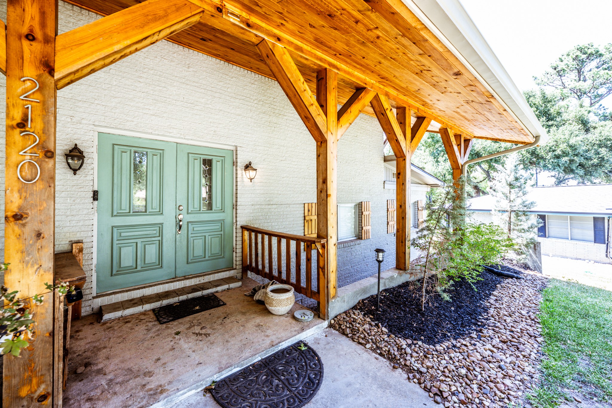 a view of a house with a small yard and wooden fence