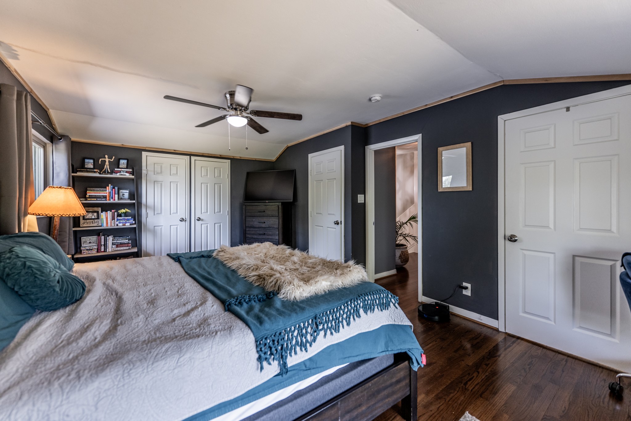 2120 Ave R Huntsville, TX 77340 - Photo 19 of 31 a bedroom with a large bed and a chandelier