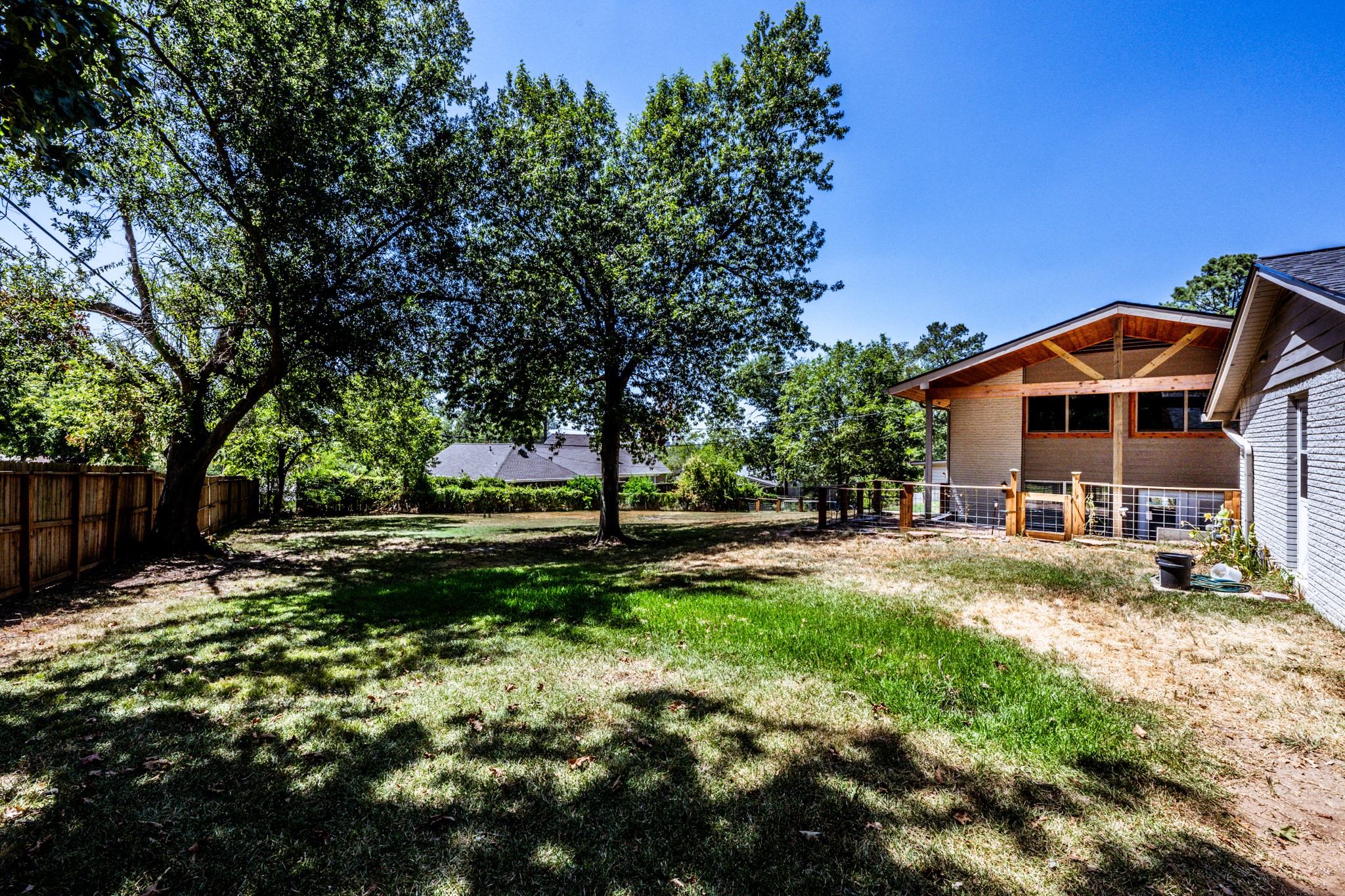 2120 Ave R Huntsville, TX 77340 - Photo 27 of 31 a view of a house with a big yard and large trees