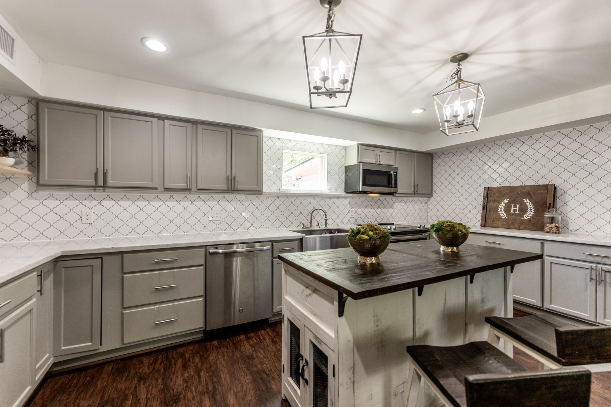 2120 Ave R Huntsville, TX 77340 - Photo 3 of 31 a kitchen with stainless steel appliances granite countertop a sink dishwasher a stove and a microwave oven with wooden floor