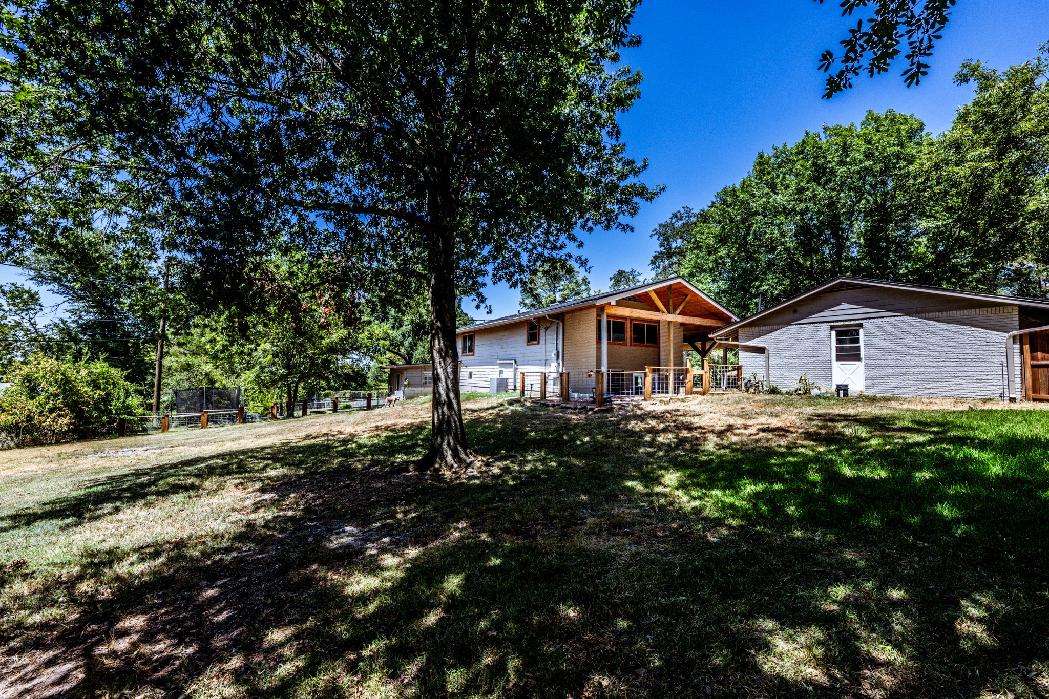 2120 Ave R Huntsville, TX 77340 - Photo 31 of 31 a house with green field in front of it
