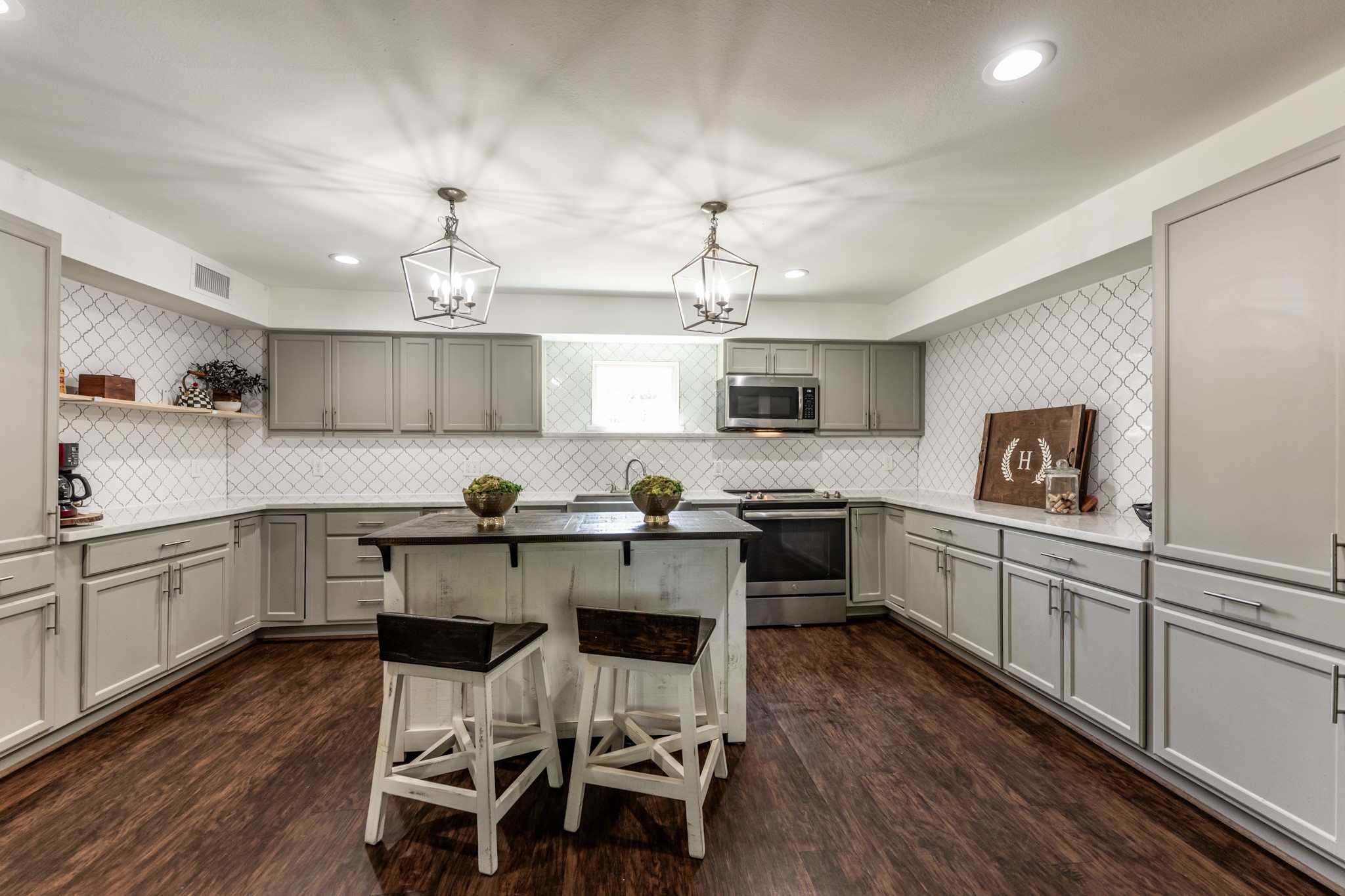 2120 Ave R Huntsville, TX 77340 - Photo 9 of 31 a kitchen with a sink cabinets and wooden floor