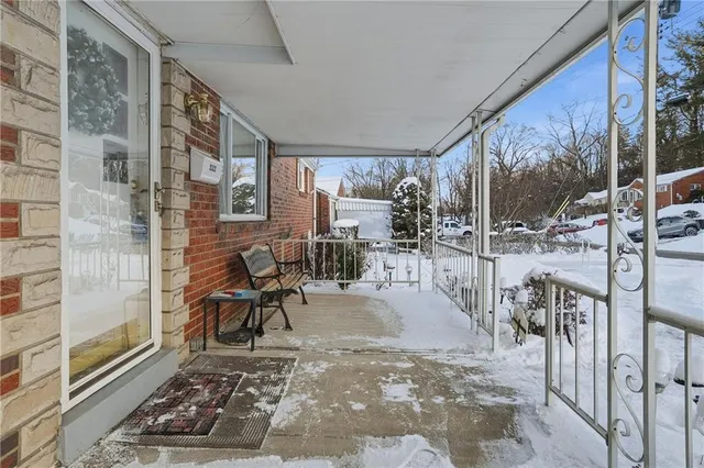 a view of a porch with chairs and backyard