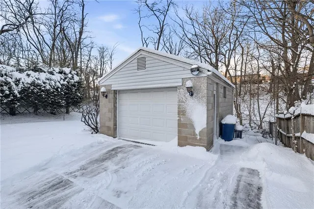 a view of a house with a yard and tree