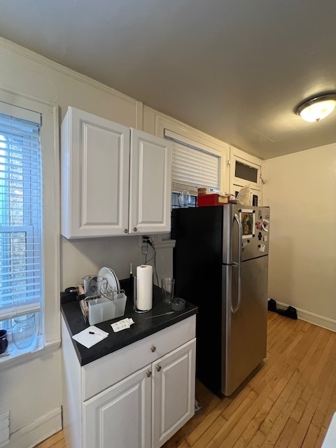 4224 North Clark Street, Unit 3 Chicago, IL 60613 - Photo 9 of 15 a kitchen with stainless steel appliances a refrigerator and cabinets