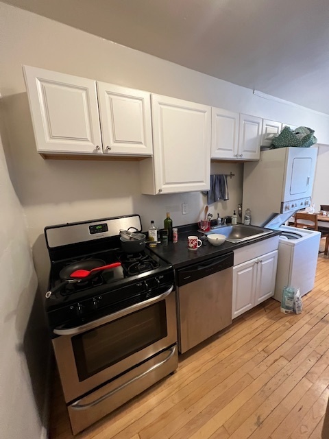 4224 North Clark Street, Unit 3 Chicago, IL 60613 - Photo 10 of 15 a kitchen with stainless steel appliances a stove a microwave and cabinets