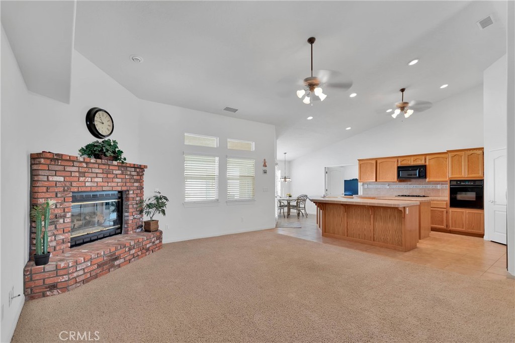 17367 Central Road Apple Valley, CA 92307 - Photo 14 of 61 a living room with furniture a window and fireplace