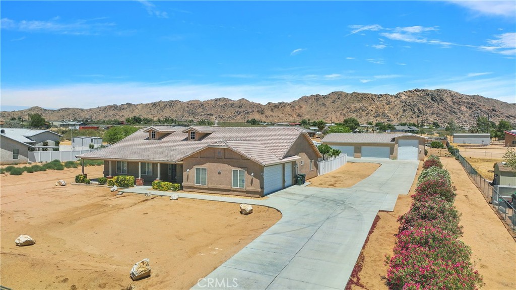 17367 Central Road Apple Valley, CA 92307 - Photo 2 of 61 a view of houses with swimming pool and mountains