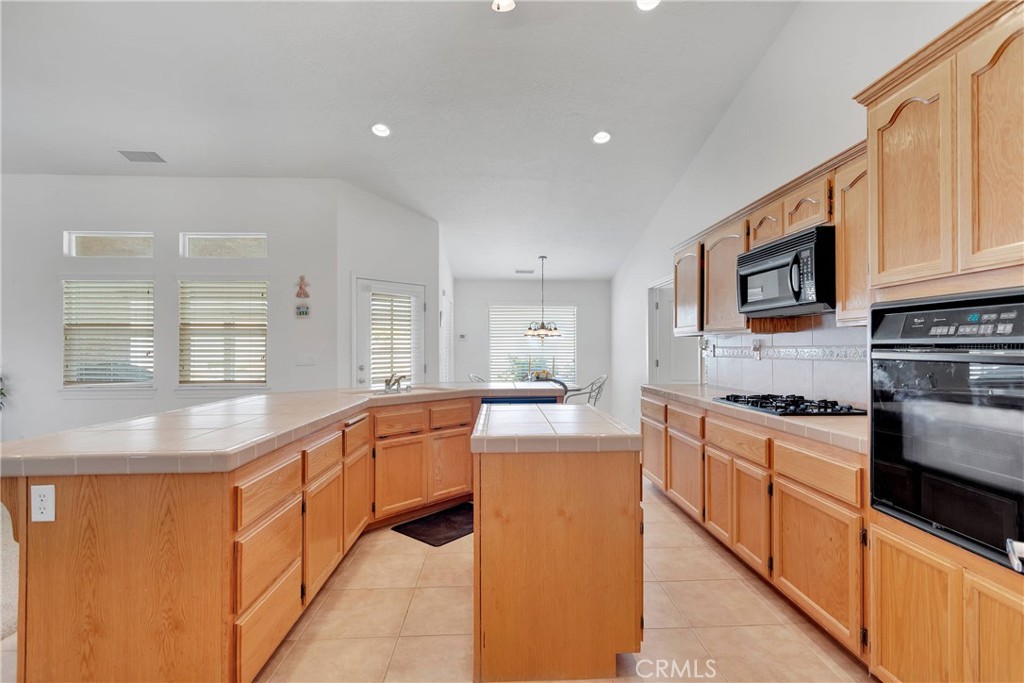 17367 Central Road Apple Valley, CA 92307 - Photo 25 of 61 a large kitchen with stainless steel appliances granite countertop a sink and cabinets