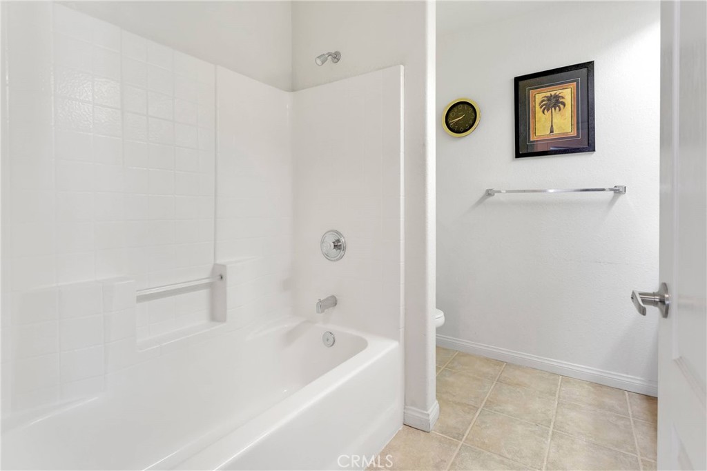 17367 Central Road Apple Valley, CA 92307 - Photo 37 of 61 a bathroom with a bathtub and a shower