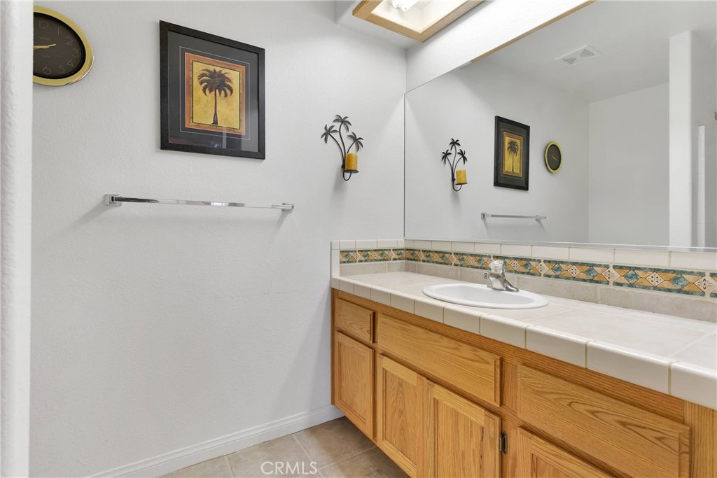 17367 Central Road Apple Valley, CA 92307 - Photo 38 of 61 a bathroom with a sink and a mirror