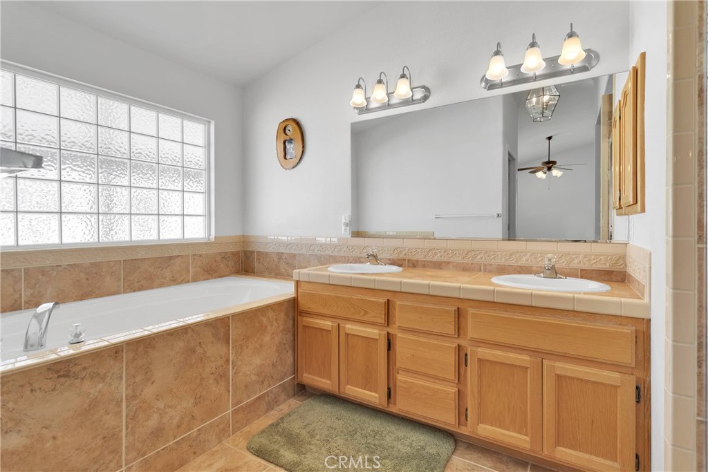 17367 Central Road Apple Valley, CA 92307 - Photo 41 of 61 a bathroom with a tub sink and mirror