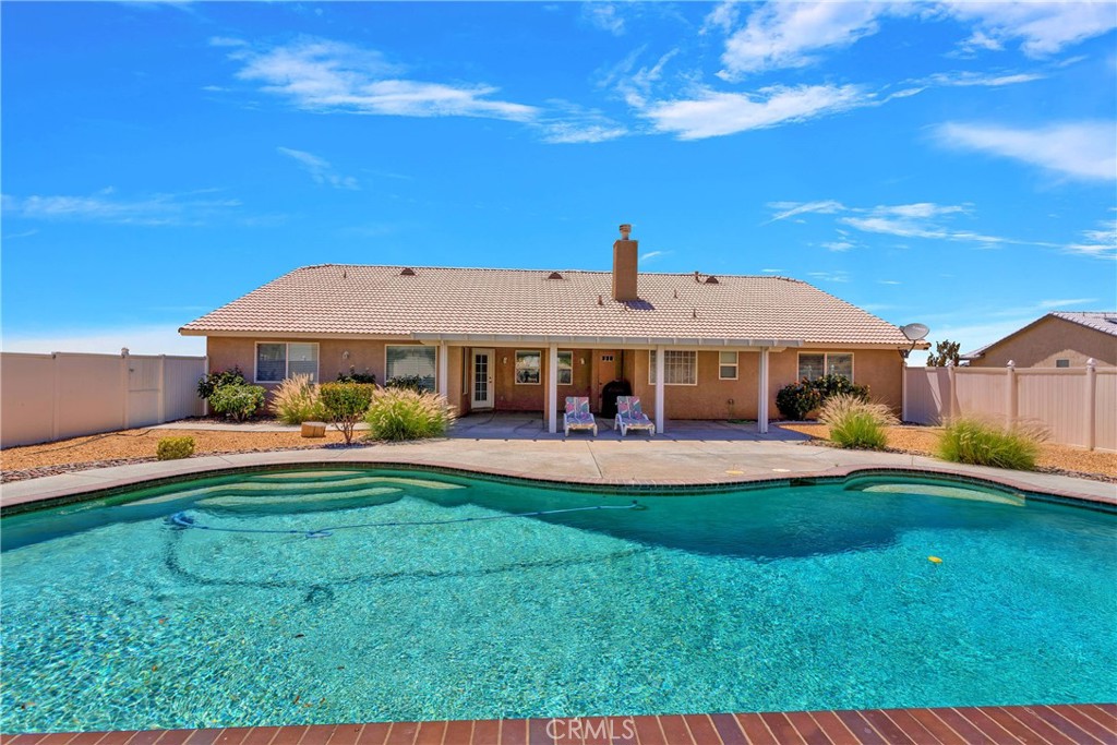 17367 Central Road Apple Valley, CA 92307 - Photo 46 of 61 a front view of a house with swimming pool having outdoor seating