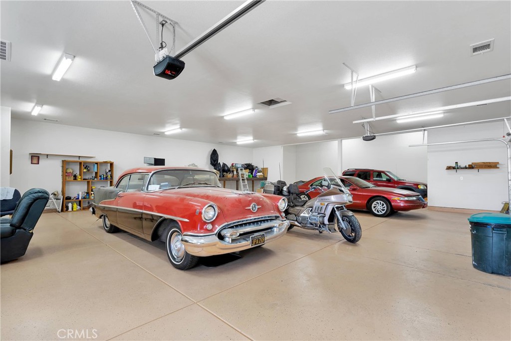 17367 Central Road Apple Valley, CA 92307 - Photo 51 of 61 a spacious bedroom with a bed and a chandelier