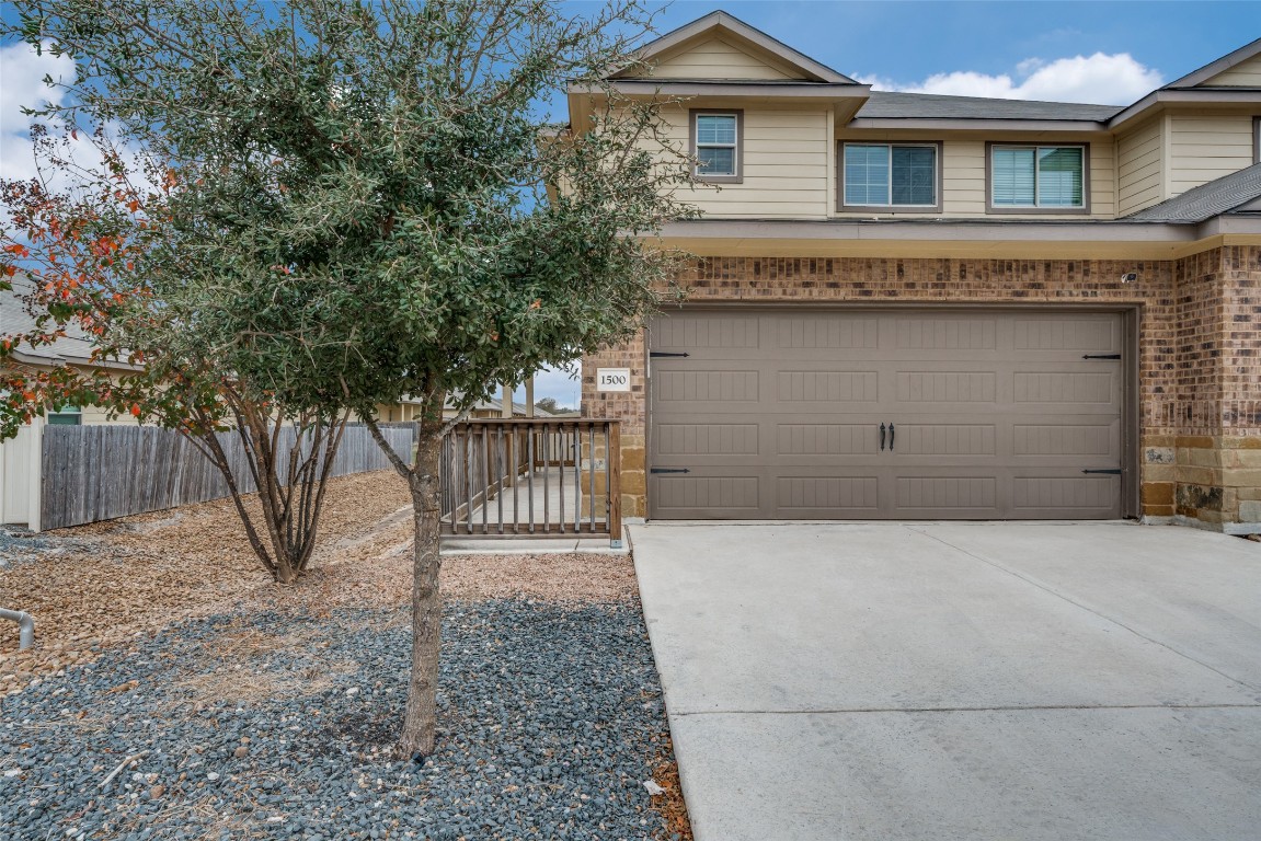 1502 Lucille Street Seguin, TX 78155 - Photo 2 of 13 a front view of a house with a yard and garage
