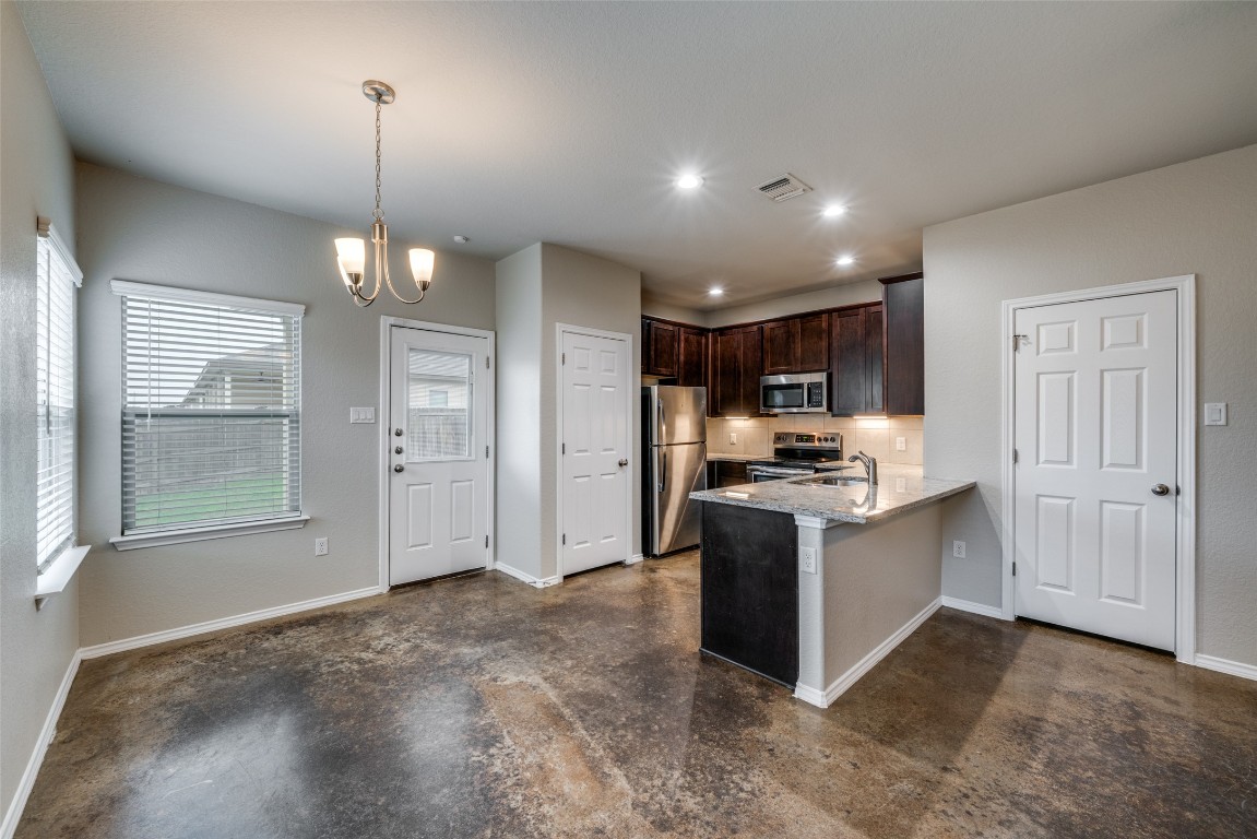 1502 Lucille Street Seguin, TX 78155 - Photo 5 of 13 a open kitchen with stainless steel appliances granite countertop a stove and a refrigerator