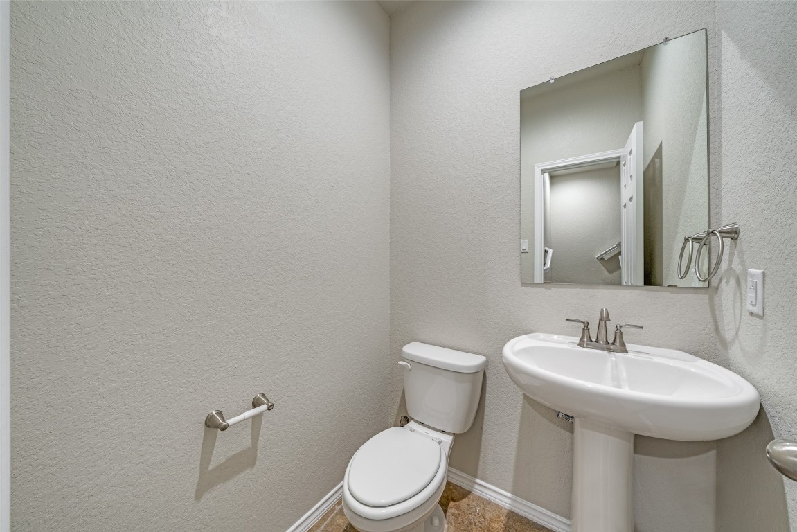 1502 Lucille Street Seguin, TX 78155 - Photo 6 of 13 a white toilet sitting next to a bathroom sink