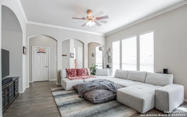 a spacious bedroom with furniture and a large window