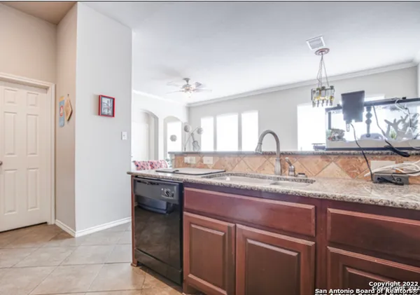 a bathroom with a granite countertop sink a mirror and vanity