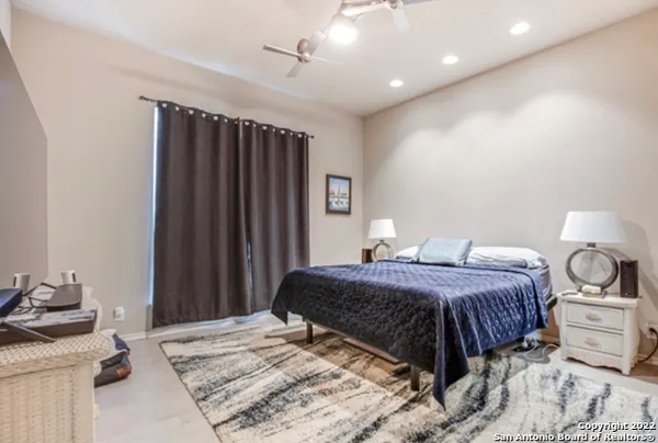 a bedroom with a bed and a mirror