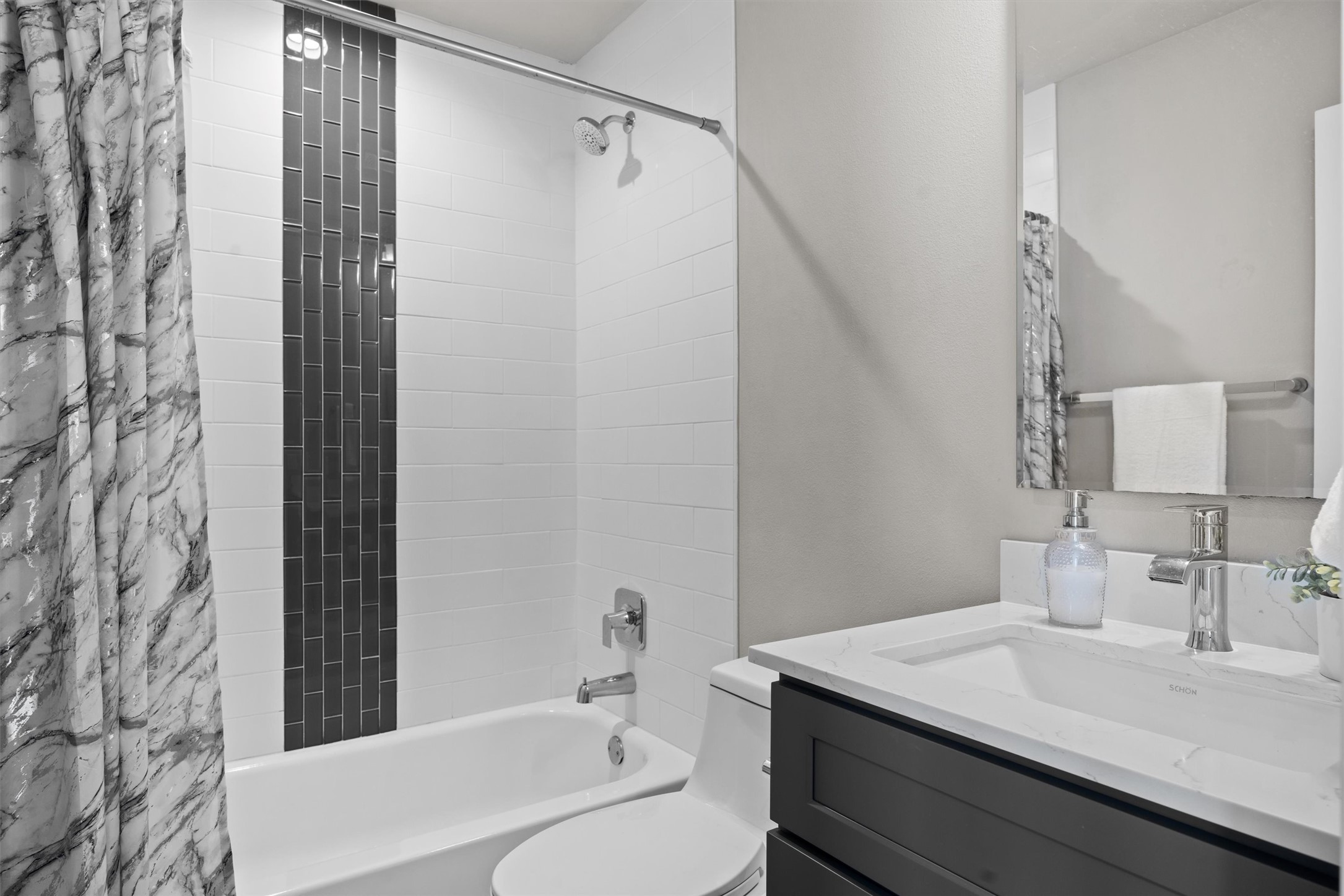 1116 Stobaugh Street, Unit B Austin, TX 78757 - Photo 24 of 38 The full guest bathroom features modern cabinetry and clean-lined finishes.