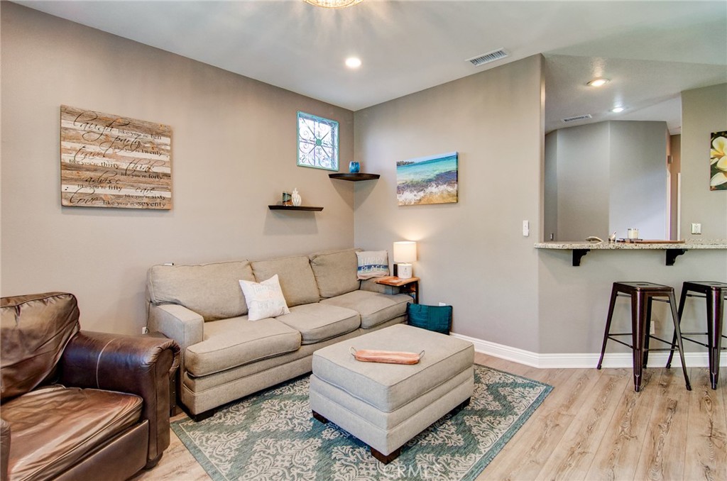 13069 Arborwalk Lane Tustin, CA 92782 - Photo 14 of 47 a living room with furniture and a wooden floor