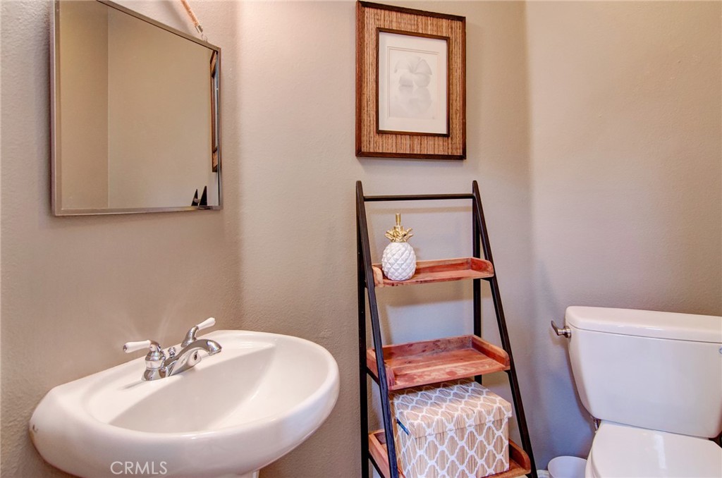 13069 Arborwalk Lane Tustin, CA 92782 - Photo 21 of 47 a bathroom with a toilet sink and mirror