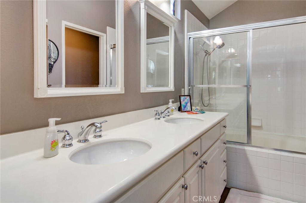 13069 Arborwalk Lane Tustin, CA 92782 - Photo 34 of 47 a bathroom with a sink and a mirror