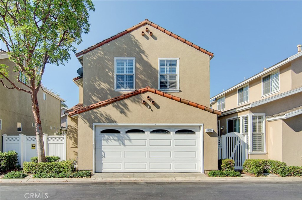13069 Arborwalk Lane Tustin, CA 92782 - Photo 9 of 47 a front view of a house with a yard and garage
