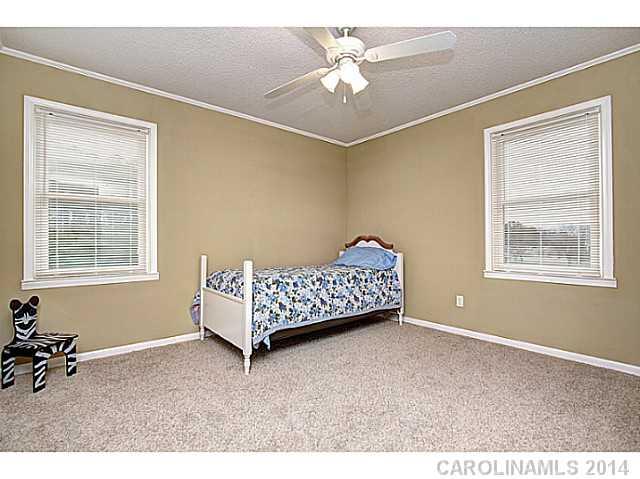 2132 Dunlap Roddey Road Rock Hill, SC 29730 - Photo 11 of 16 a bedroom with a bed and a chandelier