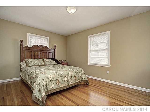 2132 Dunlap Roddey Road Rock Hill, SC 29730 - Photo 12 of 16 a bedroom with a bed and wooden floor