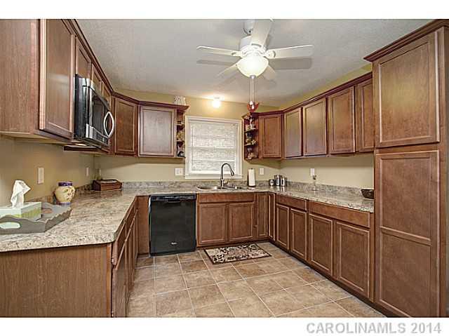 2132 Dunlap Roddey Road Rock Hill, SC 29730 - Photo 6 of 16 a kitchen with stainless steel appliances granite countertop a sink refrigerator and cabinets