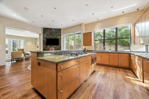 a kitchen with granite countertop a sink and a stove top oven with granite countertops