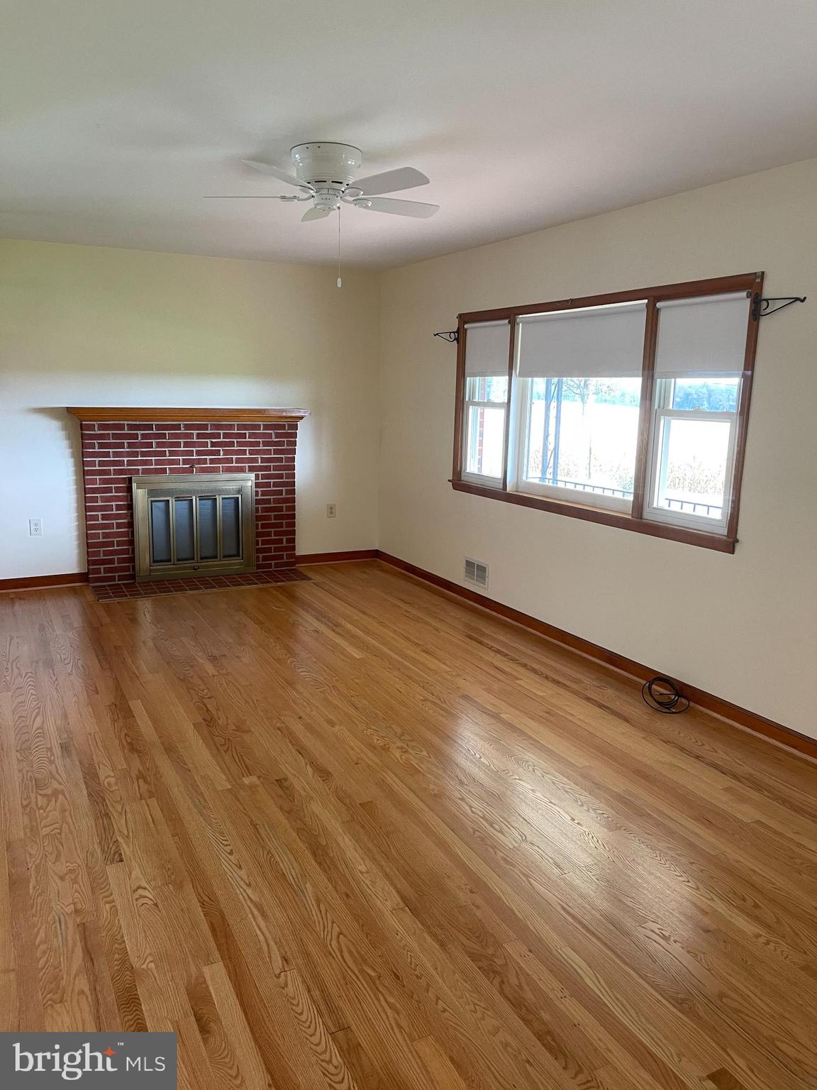 1670 Florence Road Mount Airy, MD 21771 - Photo 9 of 20 a view of an empty room with wooden floor and a window