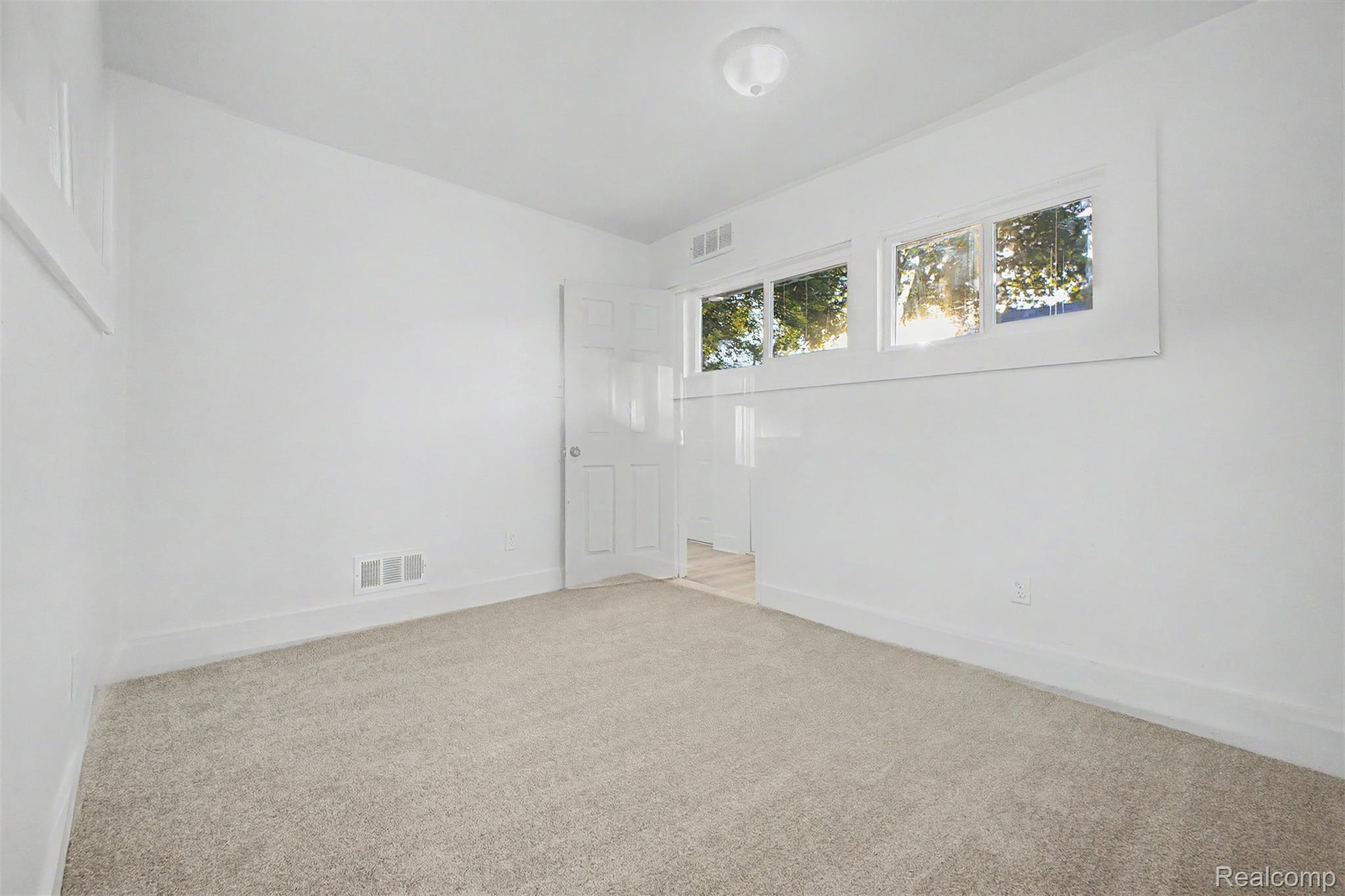 26718 Penn Street Inkster, MI 48141 - Photo 17 of 27 Bright room featuring light-toned carpeting, white walls, and white trim